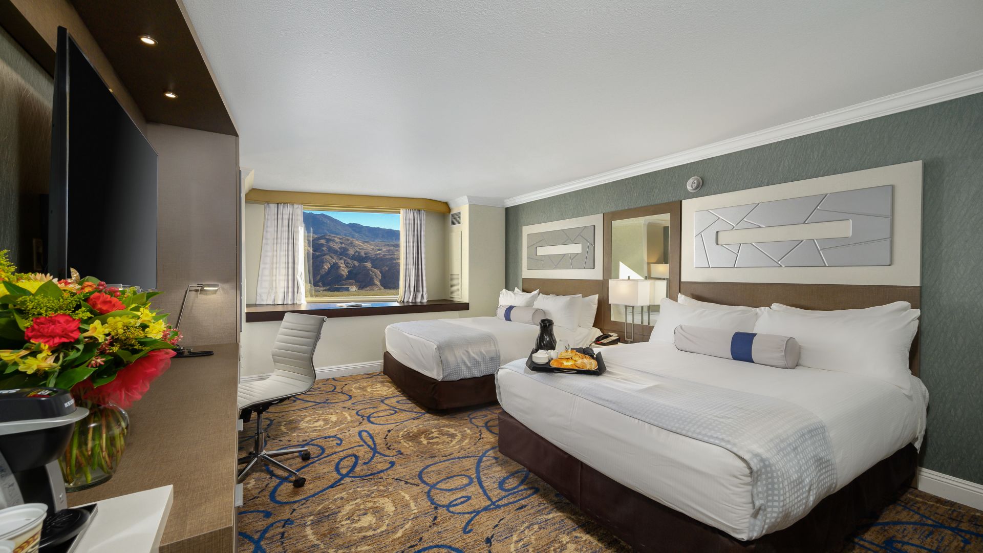A Bedroom With A Bed And Desk In A Room