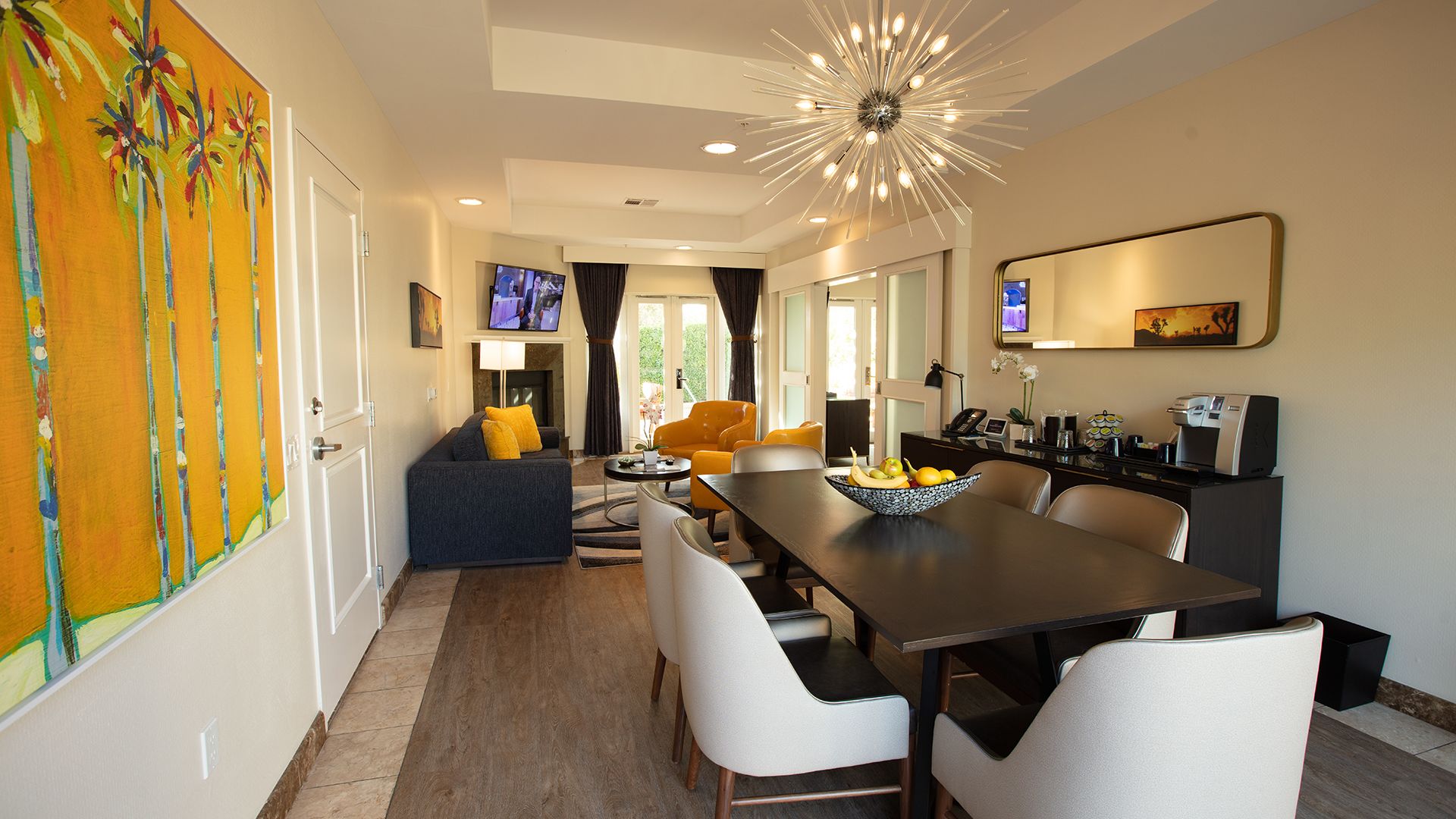 A Living Room With A Dining Table And Chairs