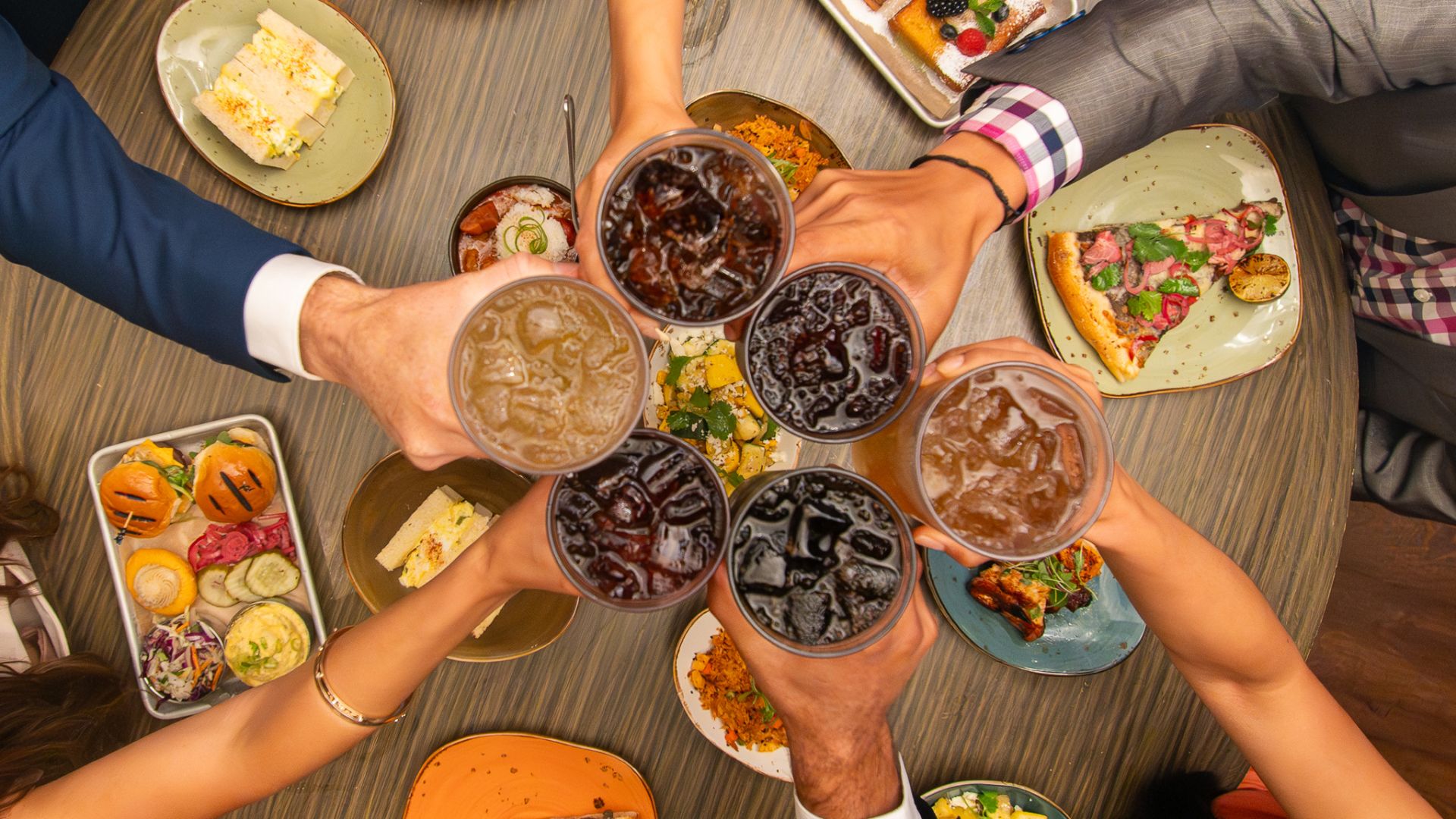 People Holding Plates Of Food