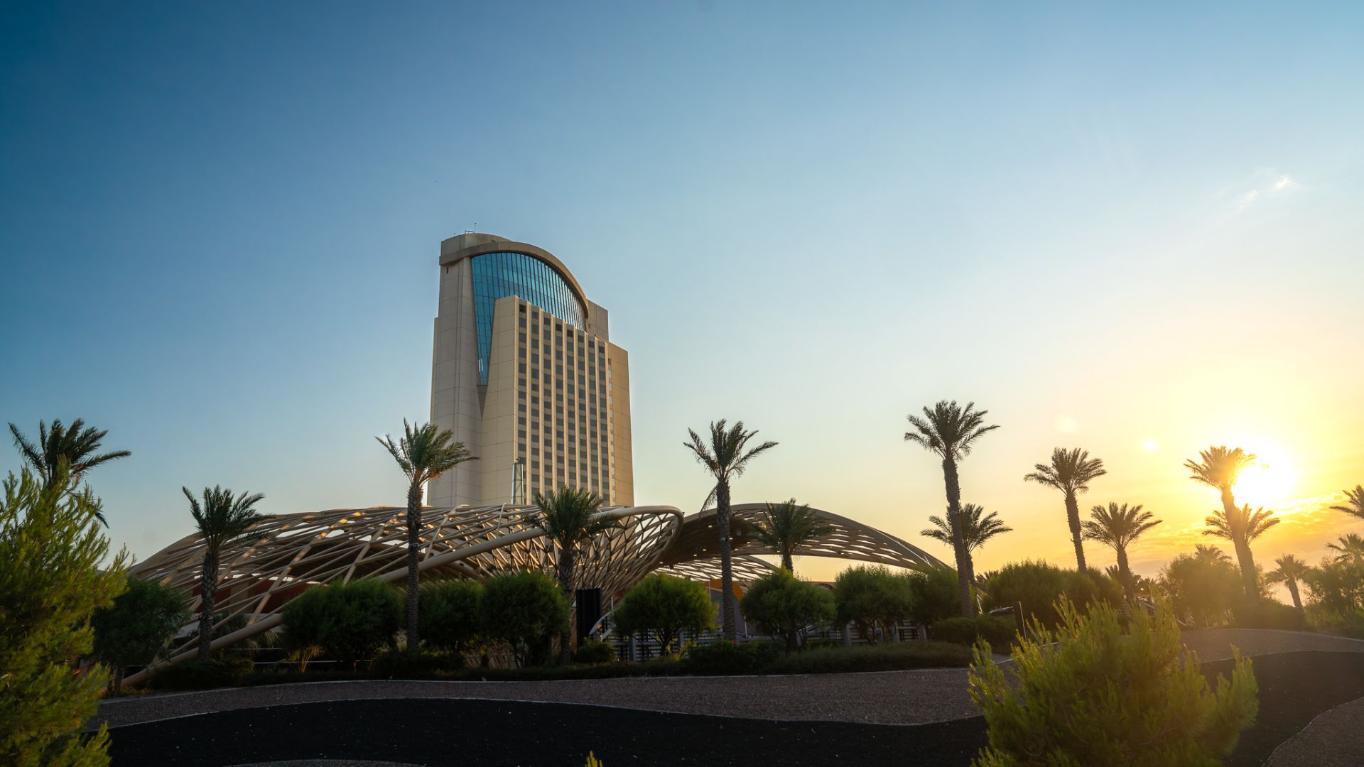 A Tall Building With Trees In Front Of It
